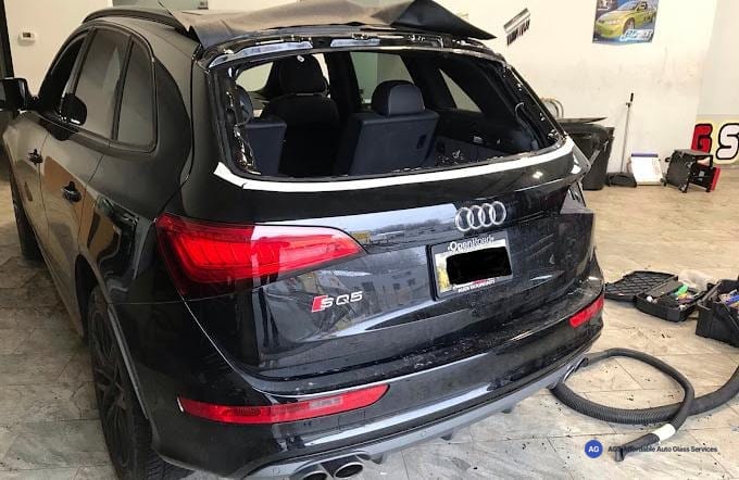 Black Audi SQ5 in the shop with its rear glass removed