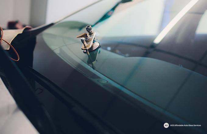 Chip repair tool mounted on a windshield