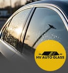 Side window of a car with water droplets at sunset