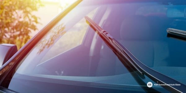 Windshield and wiper blade on a car in sunlight